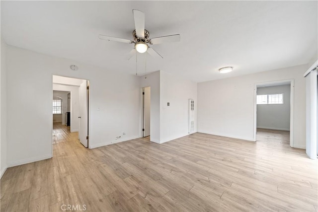 3712 Virginia Rd, Los Angeles, CA 90016 - unfurnished living room with a healthy amount of sunlight, ceiling fan, and light wood finished floors