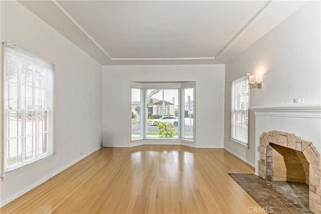 3712 Virginia Rd, Los Angeles, CA 90016 - unfurnished living room with baseboards, wood finished floors, and a tray ceiling