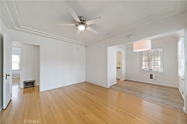 3712 Virginia Rd, Los Angeles, CA 90016 - unfurnished room with ceiling fan, light wood-style floors, arched walkways, baseboards, and visible vents