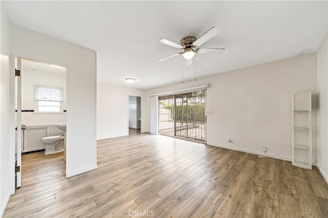 3712 Virginia Rd, Los Angeles, CA 90016 - unfurnished living room featuring light wood-style floors, baseboards, a ceiling fan, and a wealth of natural light
