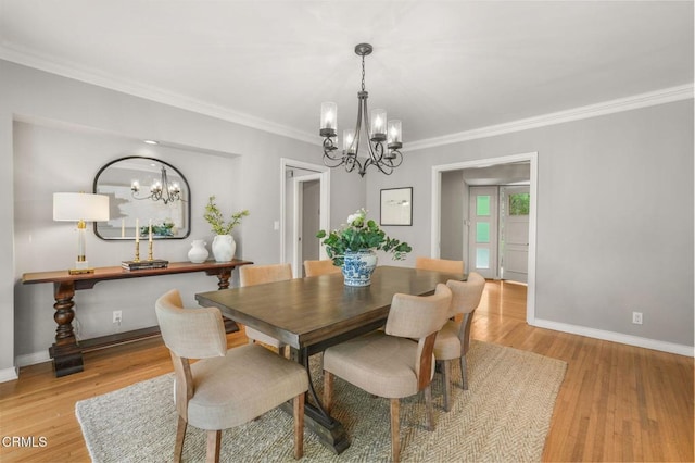 dining room with baseboards, ornamental molding, a chandelier, and light wood-type flooring