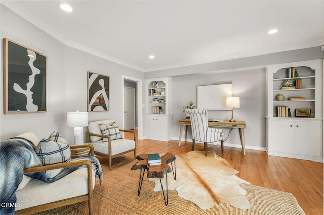 living area featuring crown molding, built in features, wood finished floors, baseboards, and recessed lighting