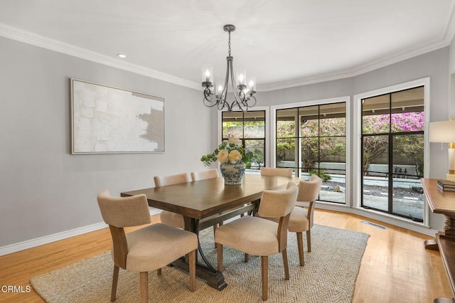 dining room featuring an inviting chandelier, crown molding, baseboards, recessed lighting, and light wood-style flooring