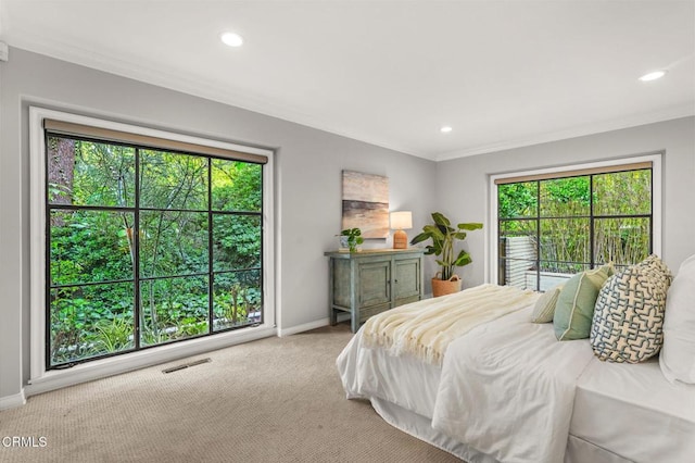 carpeted bedroom featuring baseboards, ornamental molding, visible vents, and recessed lighting