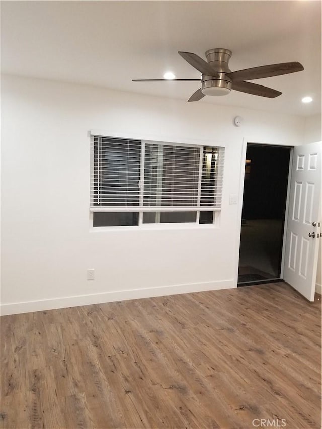 unfurnished room featuring baseboards, ceiling fan, recessed lighting, and wood finished floors