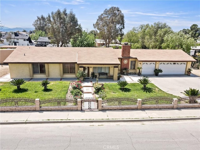 ranch-style home with an attached garage, a fenced front yard, driveway, and a chimney