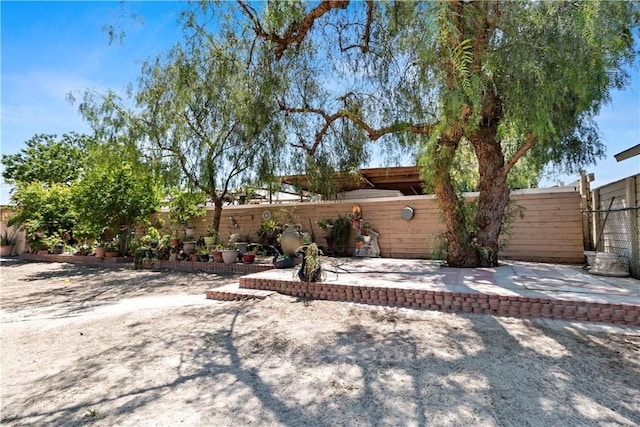back of house featuring a fenced backyard and a patio area