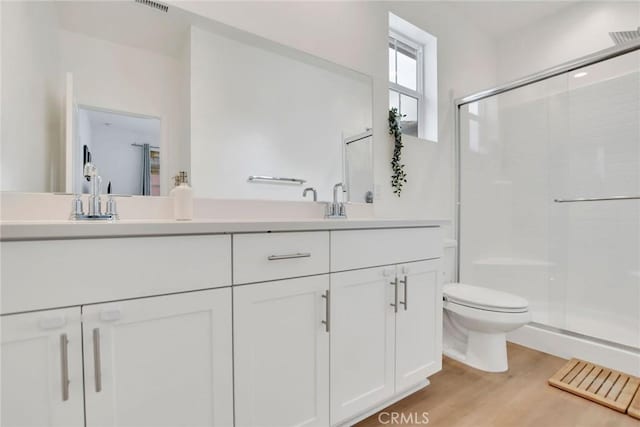 2446 E Encanto Paseo, Ontario, CA 91762 - full bathroom with a sink, double vanity, toilet, a shower stall, and wood finished floors