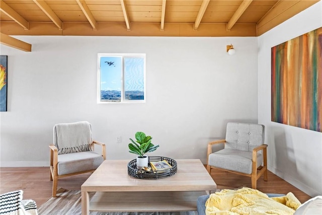 sitting room featuring wood ceiling, baseboards, beam ceiling, and wood finished floors