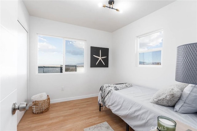 bedroom featuring baseboards and wood finished floors