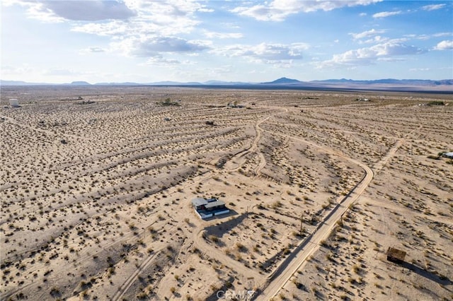 bird's eye view with a mountain view, view of desert, and a rural view