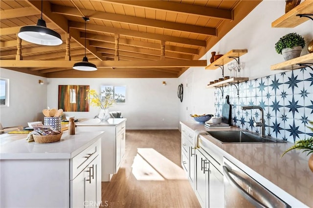 kitchen featuring open shelves, vaulted ceiling with beams, wood ceiling, a sink, and dishwasher