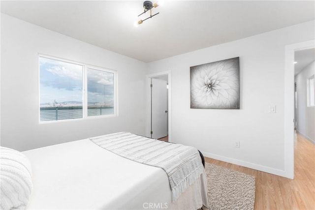 bedroom with baseboards and light wood-style flooring