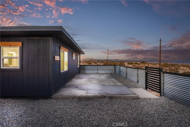 view of side of property featuring fence and a patio