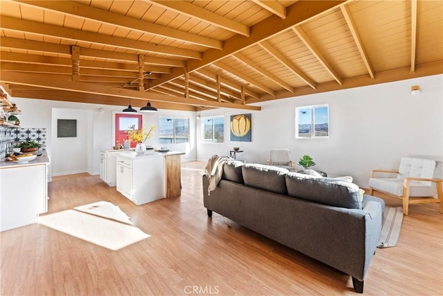 living area featuring vaulted ceiling with beams, light wood-style floors, and wooden ceiling