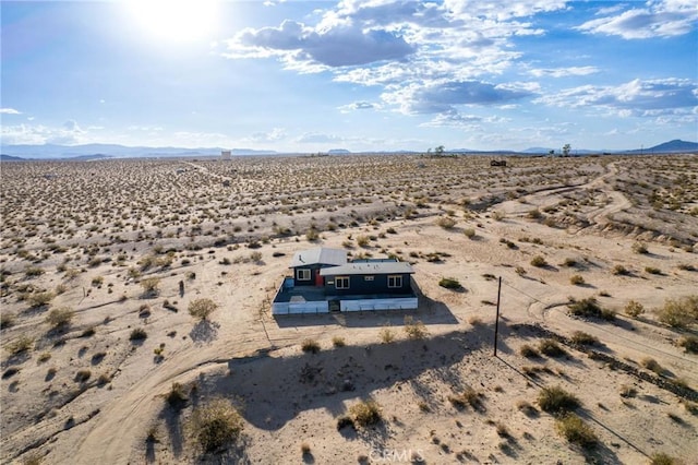 aerial view with a rural view, a mountain view, and a desert view