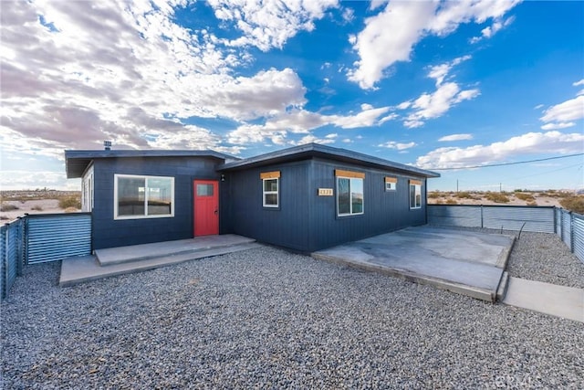view of front of property featuring a patio and a fenced backyard