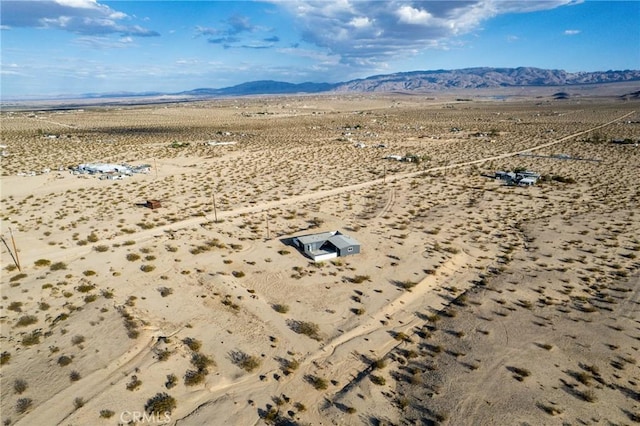 birds eye view of property featuring a rural view, a mountain view, and view of desert