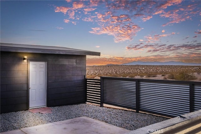 view of patio / terrace with a mountain view and fence