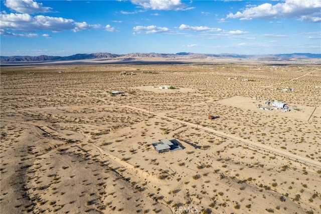 birds eye view of property with a mountain view and a desert view