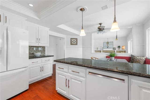 kitchen featuring ceiling fan, white appliances, dark wood finished floors, visible vents, and ornamental molding