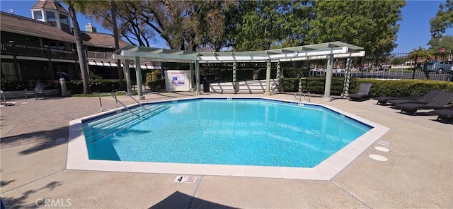pool featuring a patio area and fence