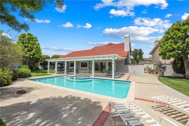 view of swimming pool with a pergola, a pool with connected hot tub, and a patio area