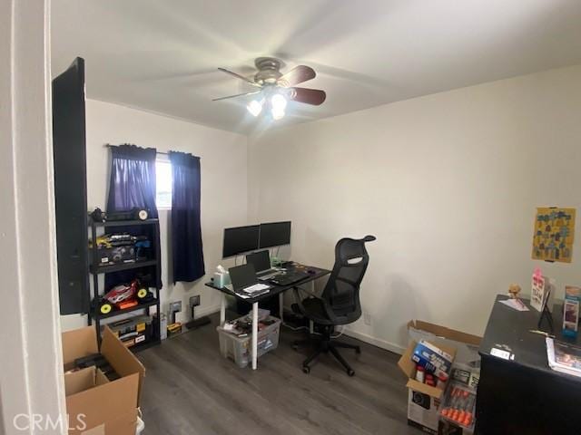 office area with a ceiling fan, baseboards, and wood finished floors
