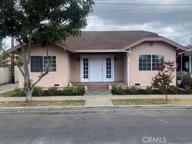 view of front of house featuring a shingled roof, stucco siding, and crawl space