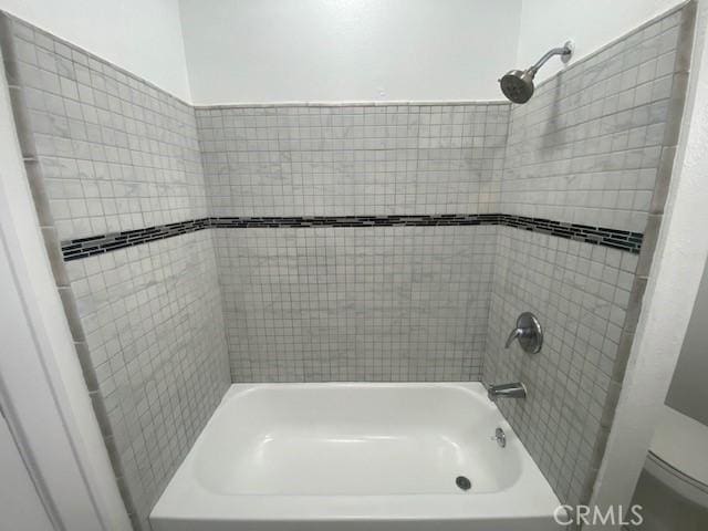 bathroom featuring toilet and  shower combination