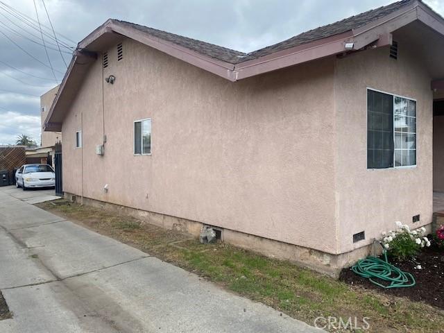 view of property exterior featuring stucco siding and crawl space