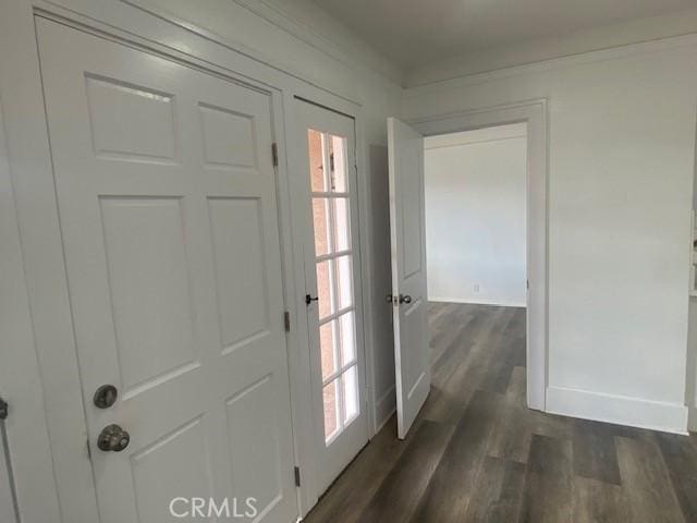entryway featuring baseboards and dark wood finished floors