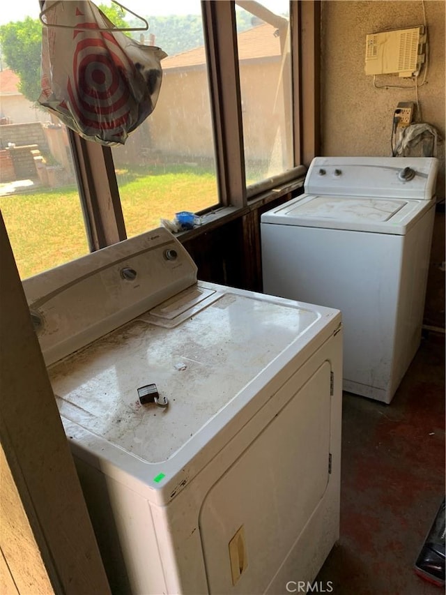 washroom with laundry area, plenty of natural light, and washer and clothes dryer