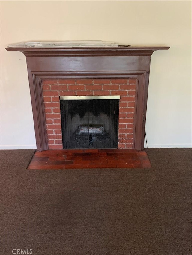 interior details featuring carpet floors, baseboards, and a fireplace