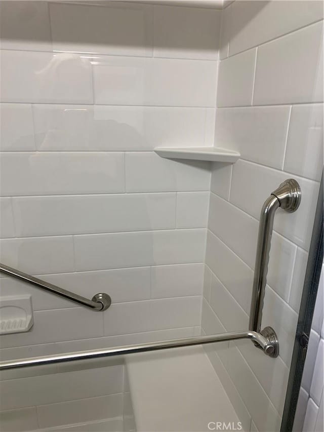full bath with a shower stall