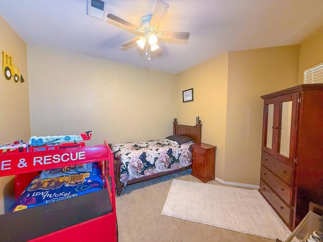 carpeted bedroom featuring visible vents, baseboards, and ceiling fan