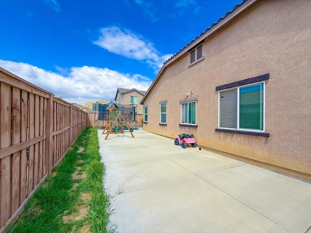 view of patio / terrace with a fenced backyard and a playground