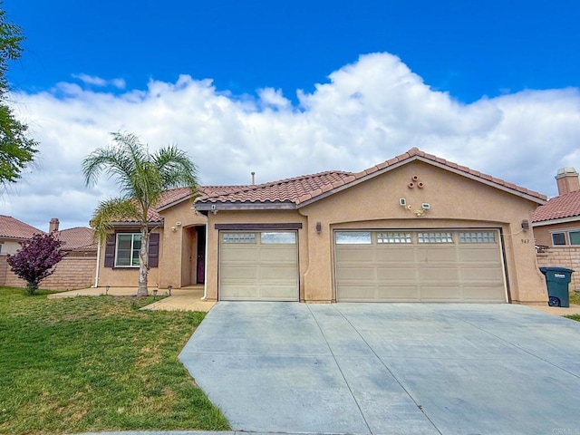 mediterranean / spanish-style house featuring an attached garage, concrete driveway, a tile roof, and stucco siding