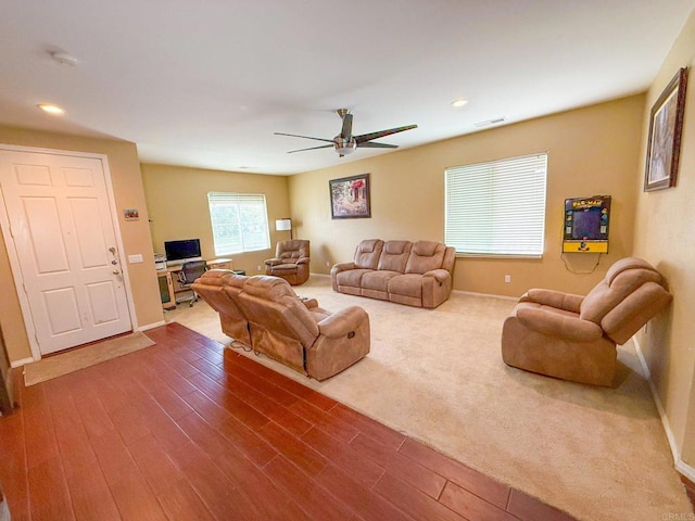 living room featuring ceiling fan, visible vents, wood finished floors, baseboards, and recessed lighting