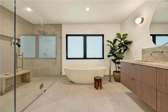 full bathroom with tile patterned floors, a freestanding bath, and a stall shower