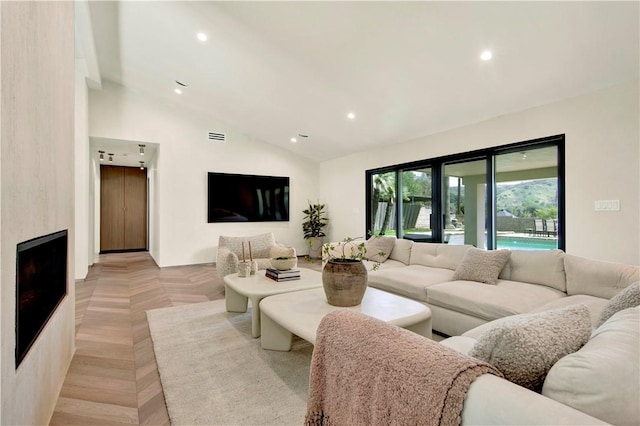 living room featuring recessed lighting, vaulted ceiling, and visible vents