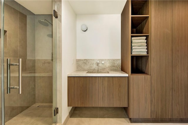 bathroom featuring vanity, tile patterned flooring, and a shower stall