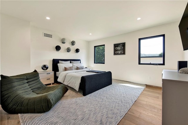 bedroom featuring recessed lighting, visible vents, and light wood-style flooring