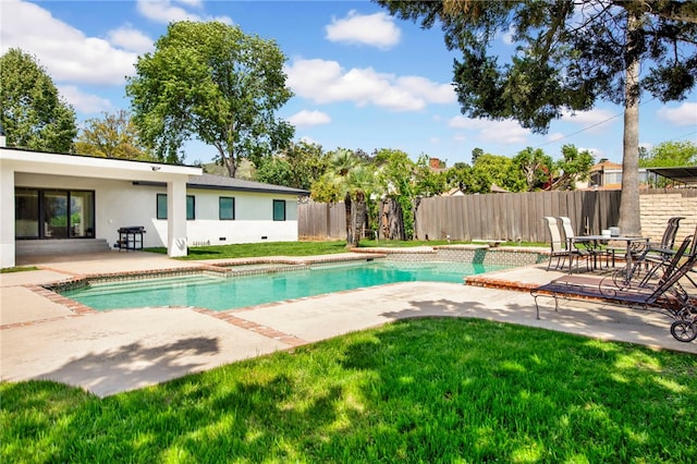 view of swimming pool featuring fence, a patio, and a lawn
