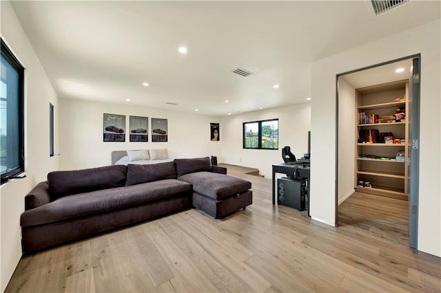 living room with visible vents, recessed lighting, and light wood finished floors