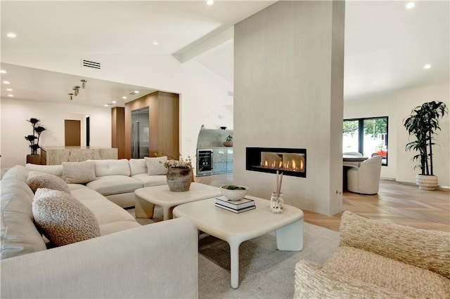living room with a large fireplace, recessed lighting, vaulted ceiling with beams, wine cooler, and visible vents