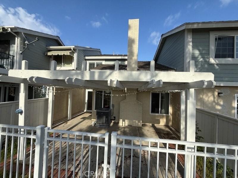 exterior space featuring central AC unit, a patio area, and fence