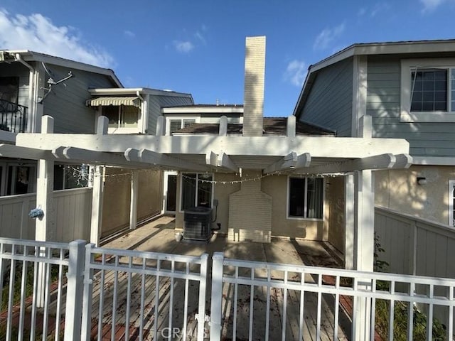 exterior space featuring central AC unit, a patio area, and fence
