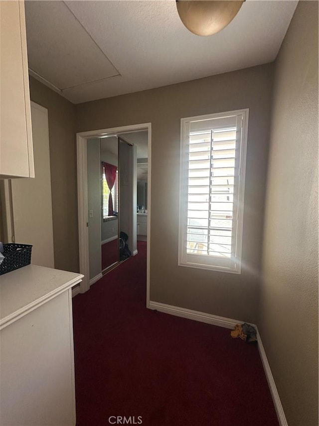 21205 Serra Unit 42, Lake Forest, CA 92630 - hallway with baseboards and dark carpet