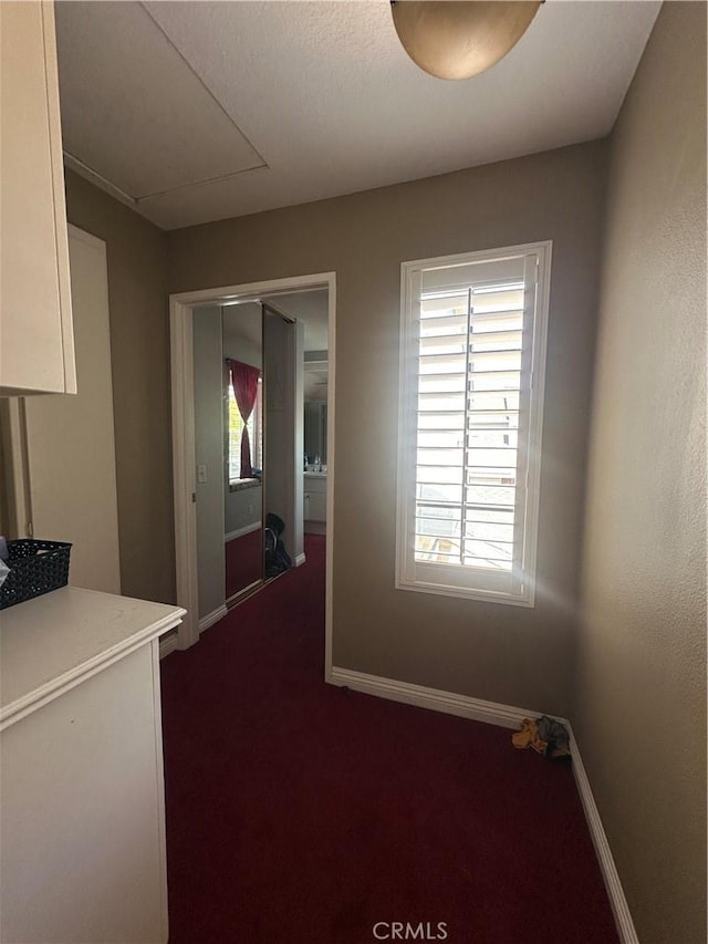 21205 Serra Unit 42, Lake Forest, CA 92630 - corridor featuring baseboards and dark colored carpet